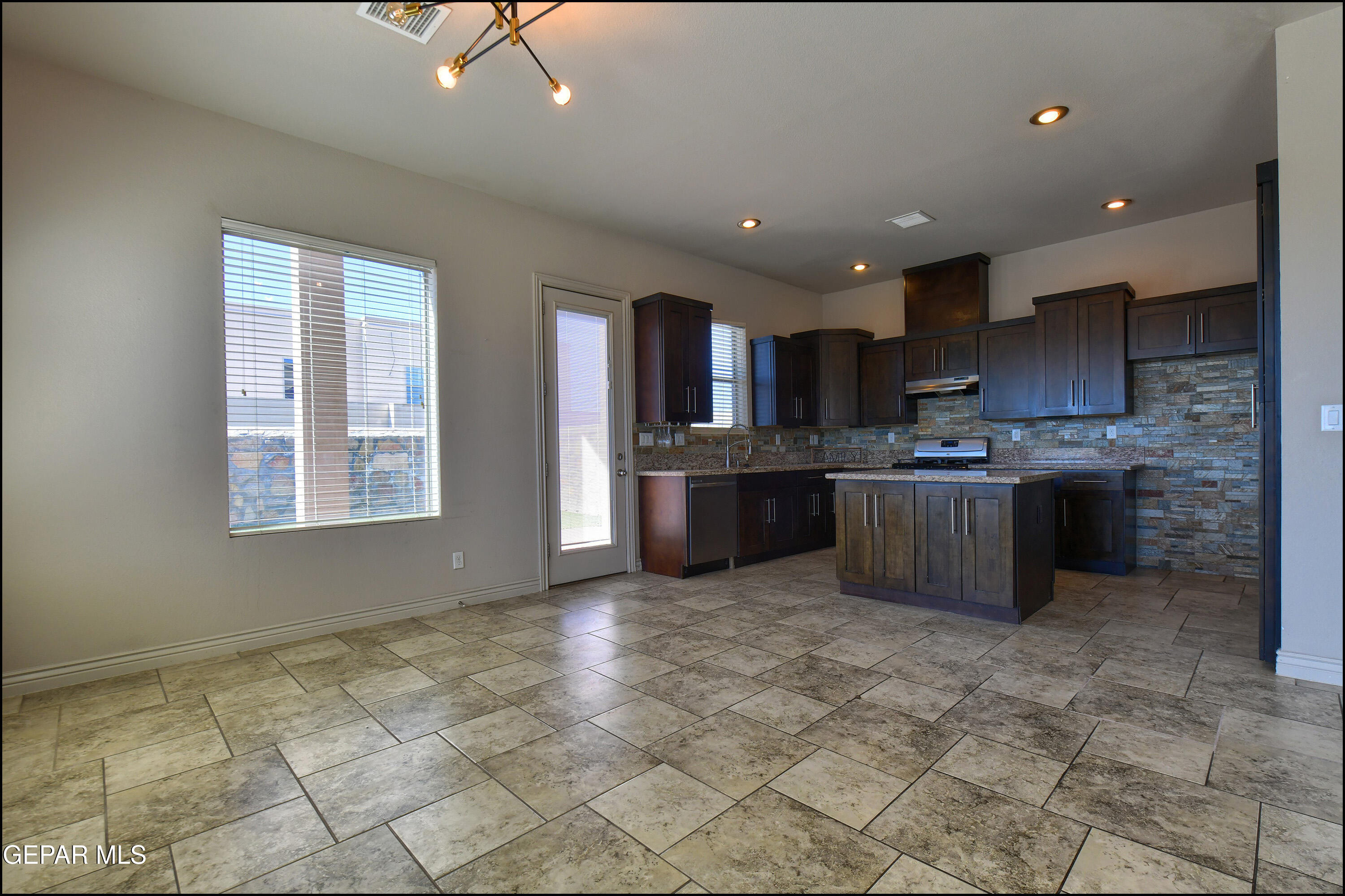 401 Ana Way, Unit B El Paso, TX 79912 - Photo 10 of 54 a kitchen with stainless steel appliances granite countertop a stove sink and cabinets