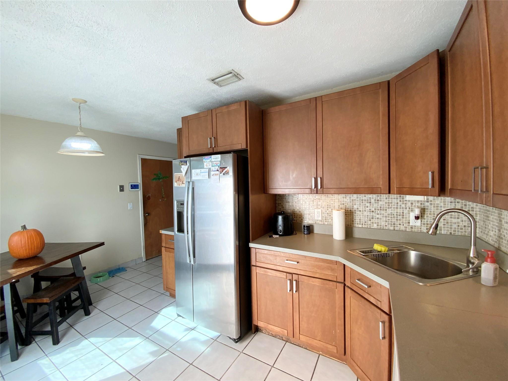 8160 Southwest 6th Street North Lauderdale, FL 33068 - Photo 14 of 39 a kitchen with a sink cabinets and stainless steel appliances