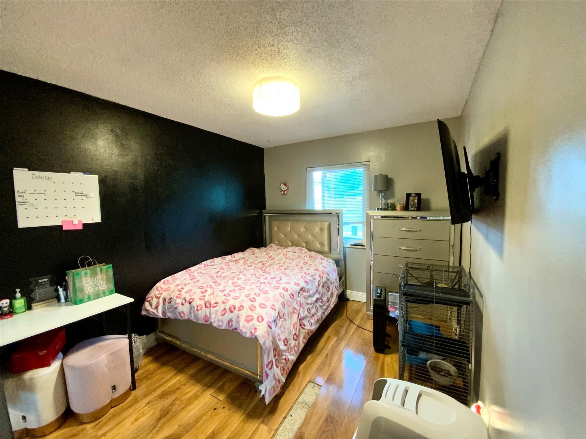 8160 Southwest 6th Street North Lauderdale, FL 33068 - Photo 17 of 39 a bedroom with a bed and a flat screen tv