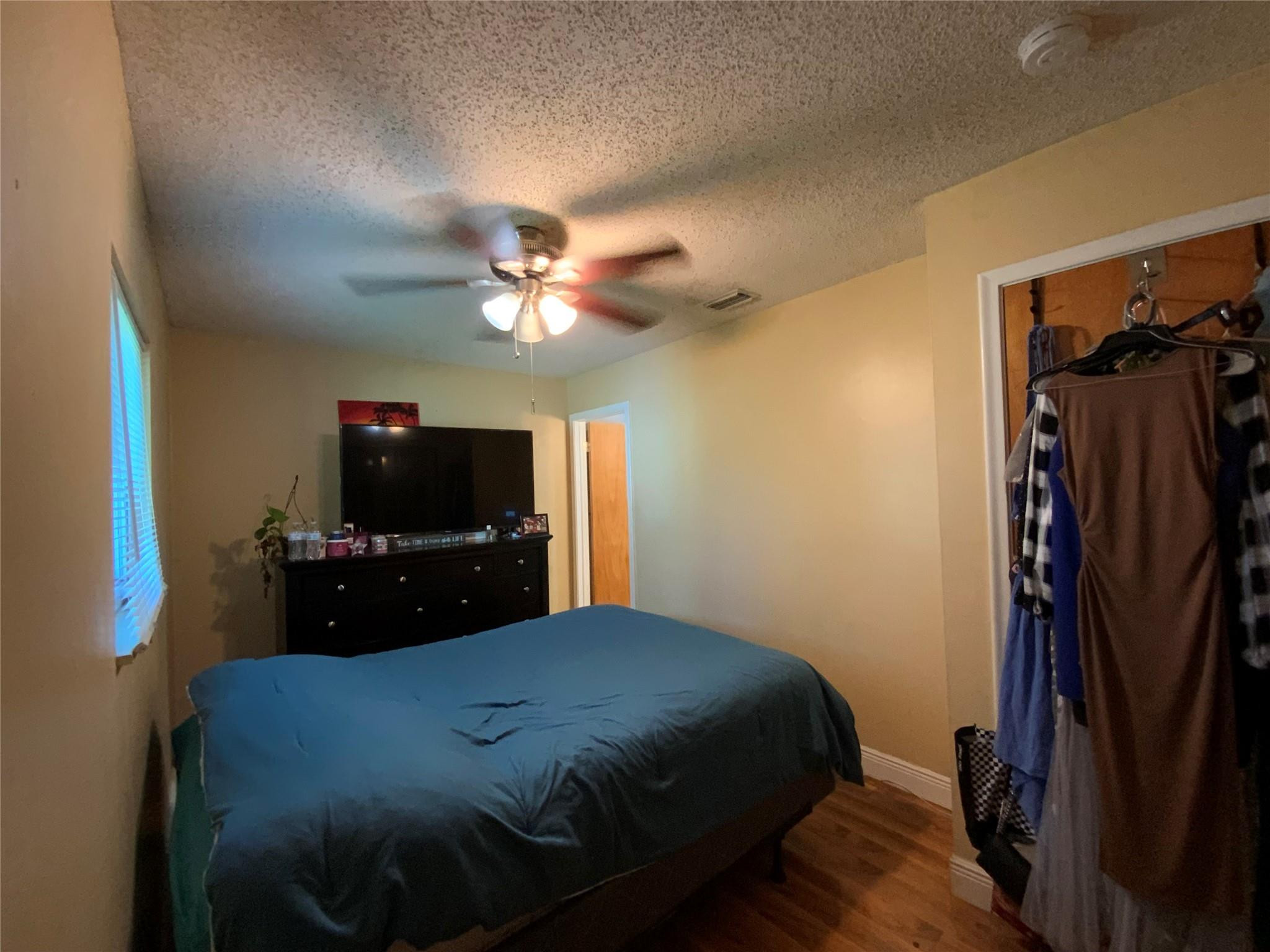 8160 Southwest 6th Street North Lauderdale, FL 33068 - Photo 21 of 39 a bedroom with a bed and a flat tv screen on a dresser