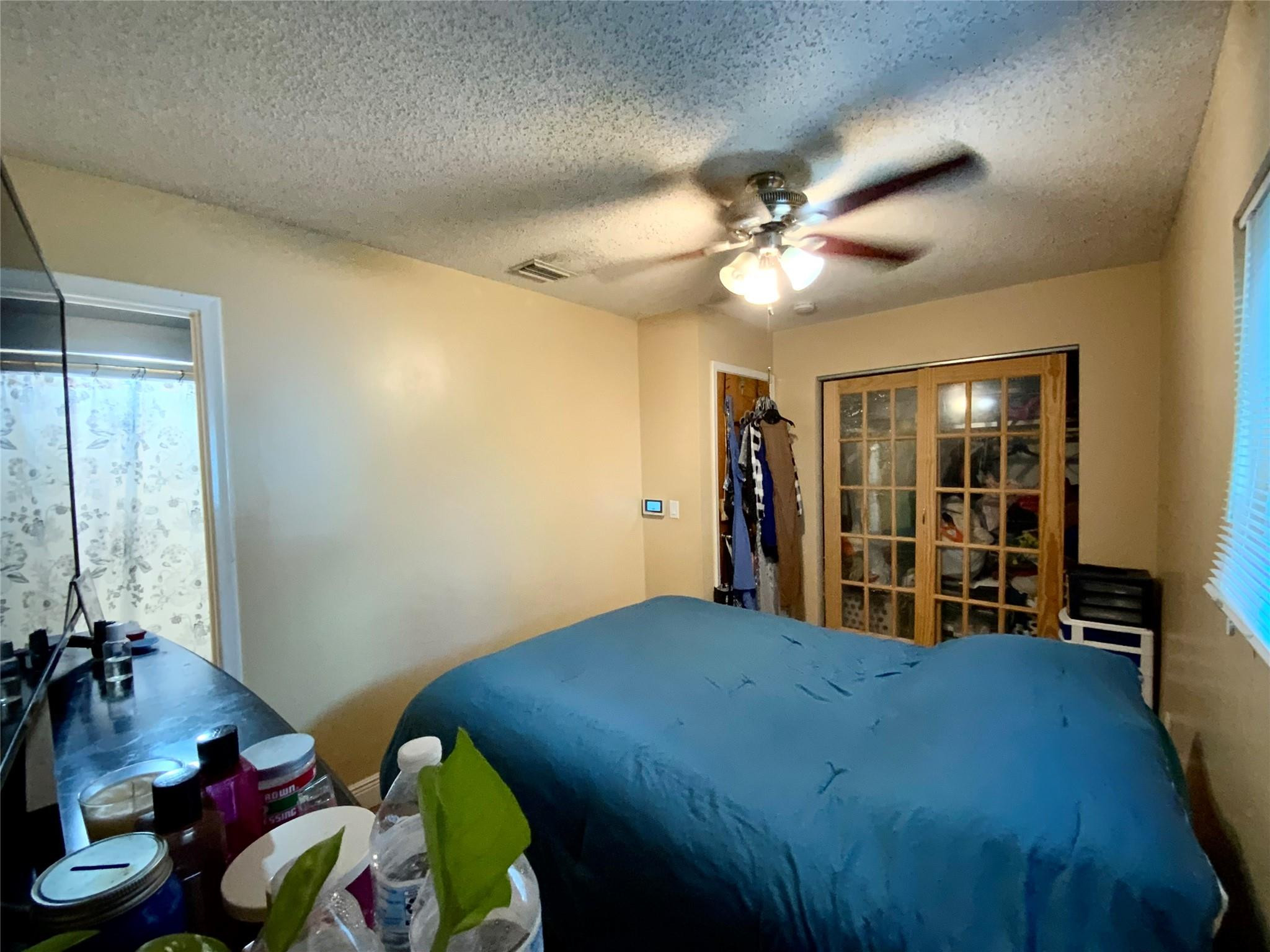 8160 Southwest 6th Street North Lauderdale, FL 33068 - Photo 22 of 39 a bed room with a bed and a chandelier