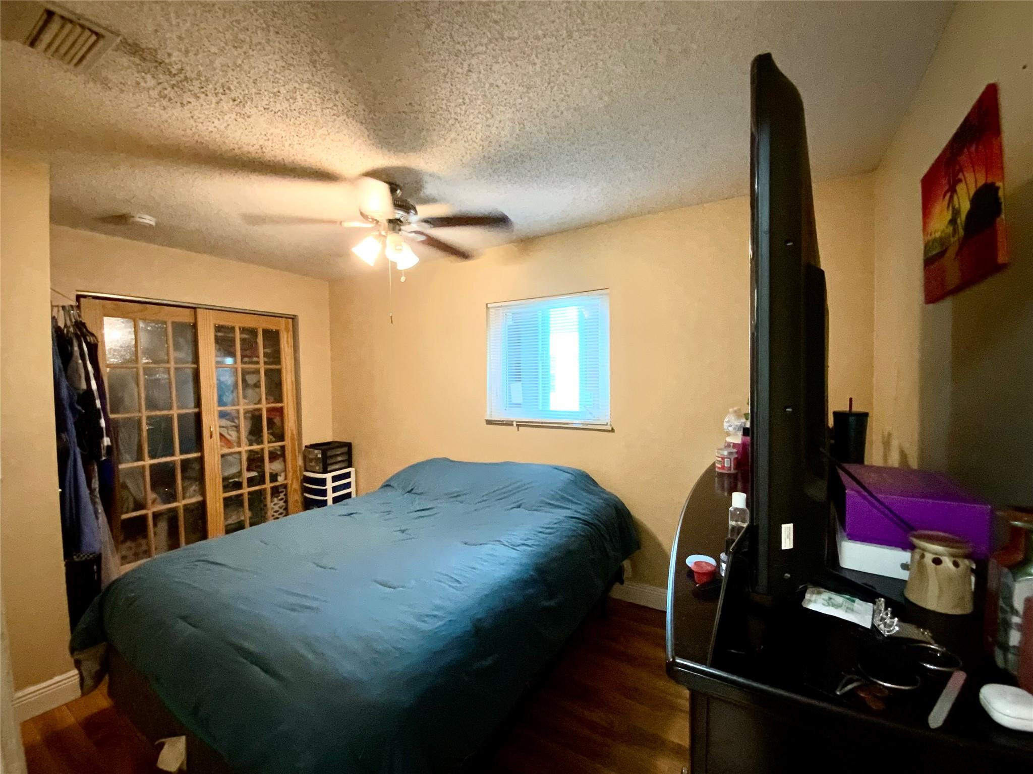 8160 Southwest 6th Street North Lauderdale, FL 33068 - Photo 23 of 39 a bed sitting in a bedroom next to a window