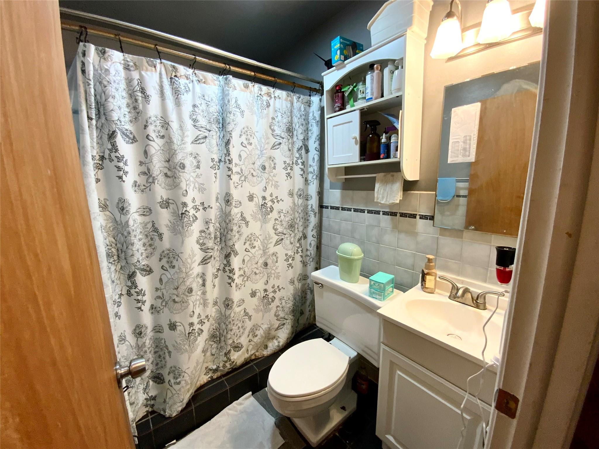8160 Southwest 6th Street North Lauderdale, FL 33068 - Photo 24 of 39 a bathroom with a toilet sink and mirror