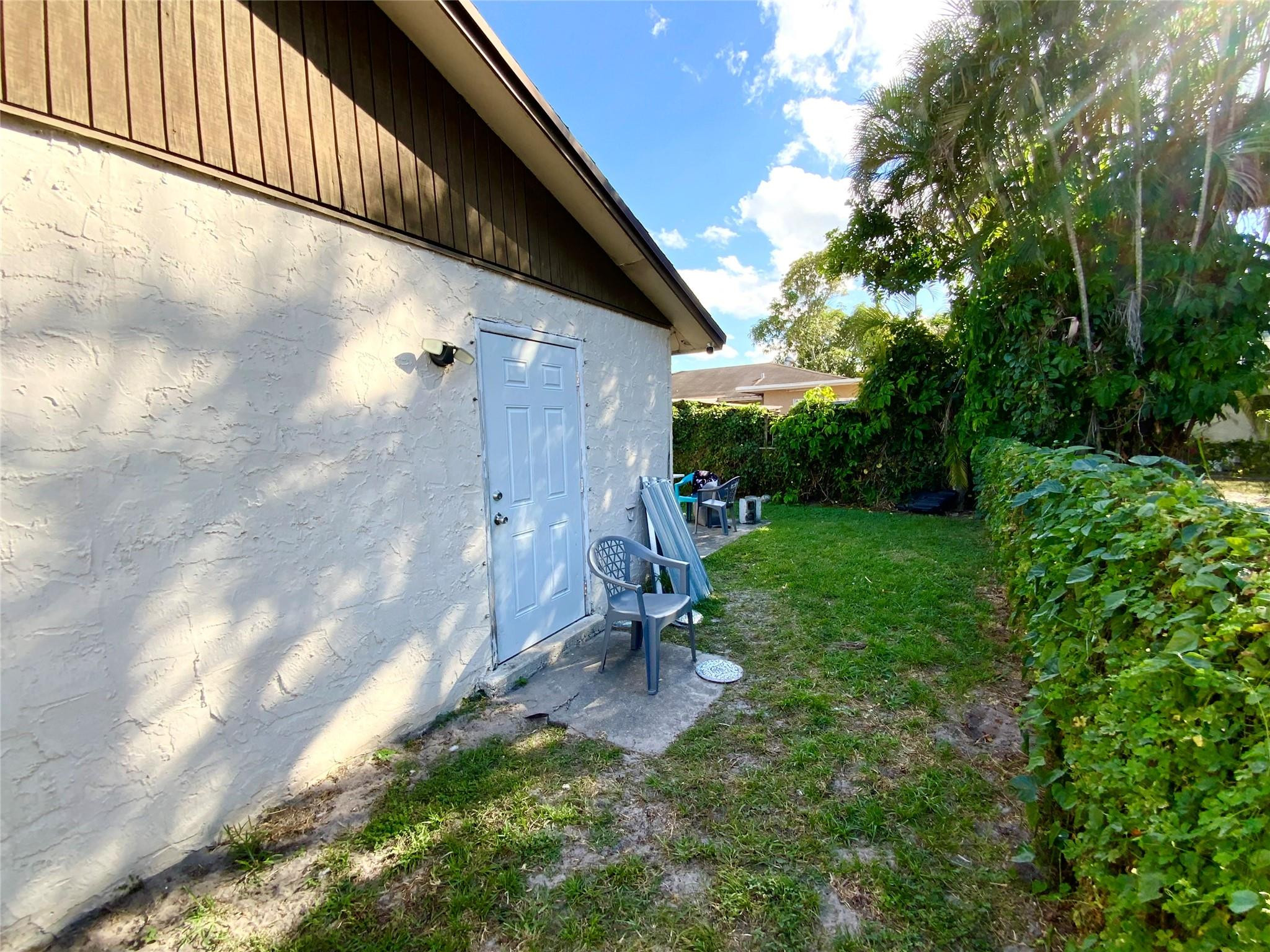 8160 Southwest 6th Street North Lauderdale, FL 33068 - Photo 35 of 39 a backyard of a house with table and chairs