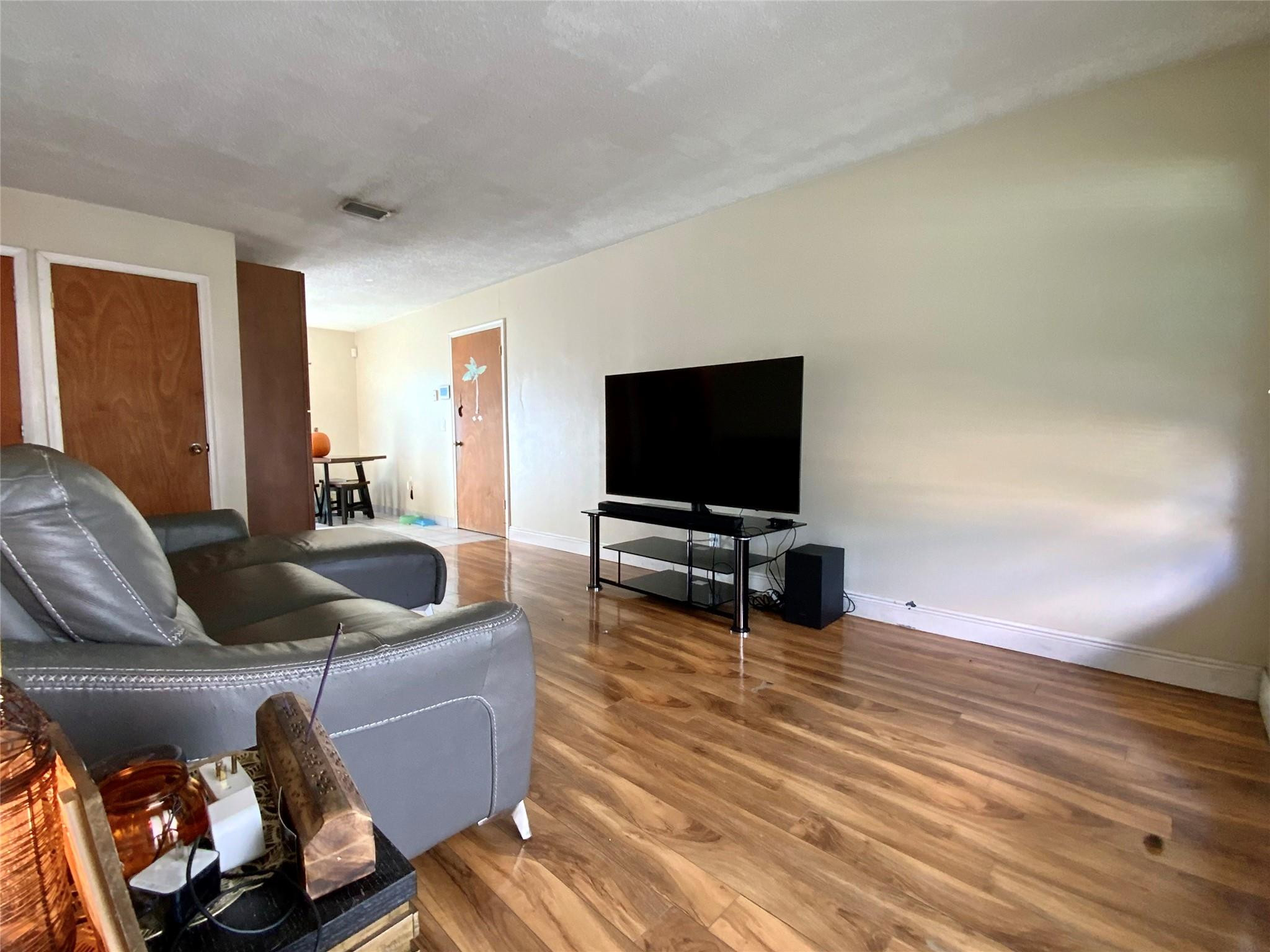 8160 Southwest 6th Street North Lauderdale, FL 33068 - Photo 6 of 39 a living room with furniture and a flat screen tv