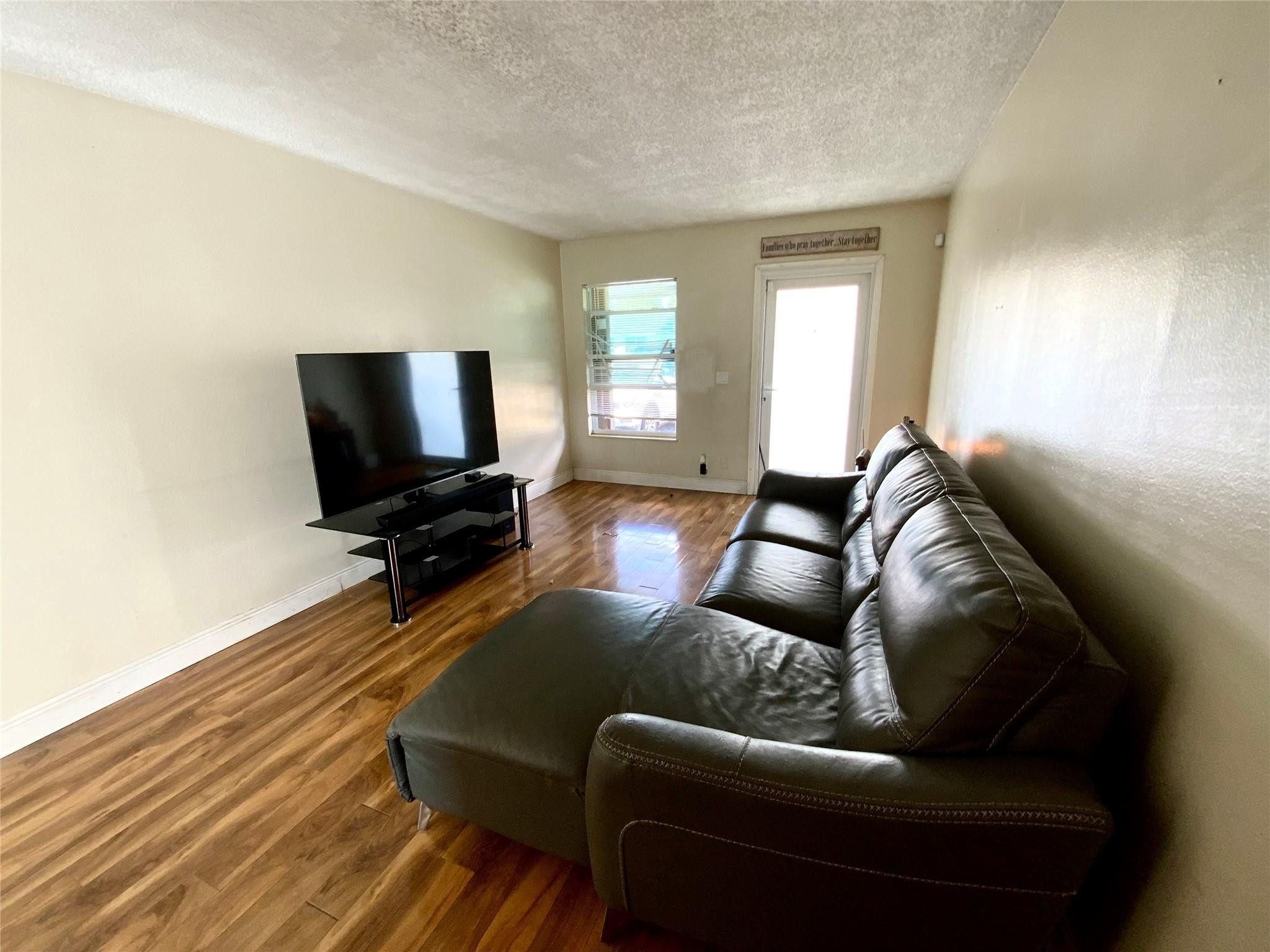 8160 Southwest 6th Street North Lauderdale, FL 33068 - Photo 9 of 39 a living room with furniture and a flat screen tv