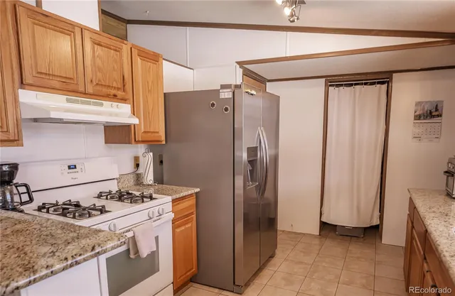 a kitchen with a refrigerator and a sink