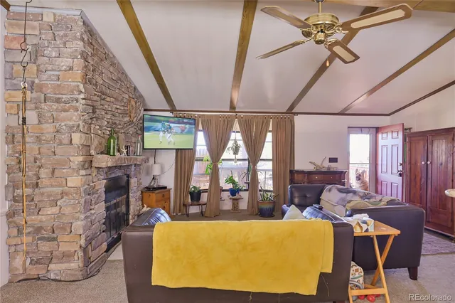 a living room with fireplace furniture and a floor to ceiling window