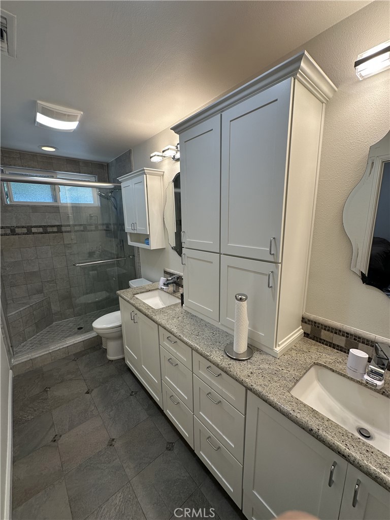 13191 Honeybee Street Moorpark, CA 93021 - Photo 12 of 27 a bathroom with a double vanity sink mirror double and shower