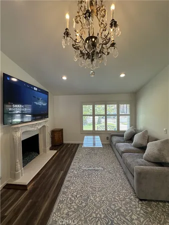 a living room with furniture fireplace and flat screen tv