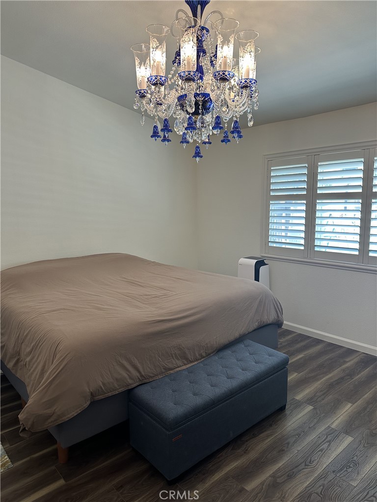 13191 Honeybee Street Moorpark, CA 93021 - Photo 9 of 27 a bedroom with a bed and a chandelier