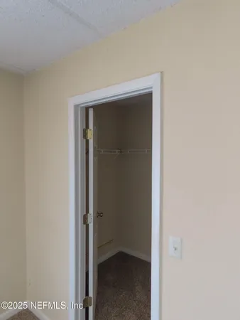 an empty room with a ceiling fan and a window