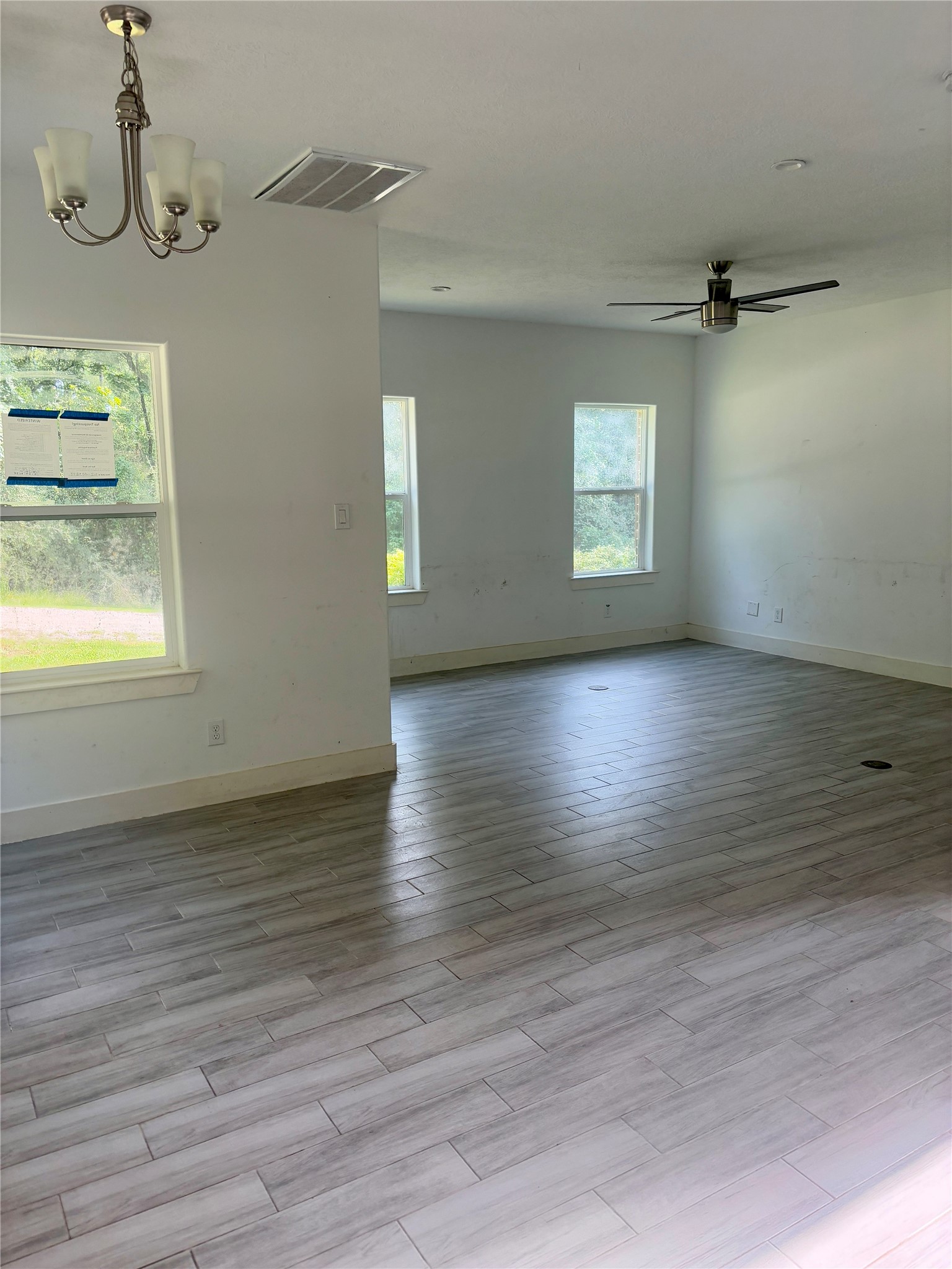 262 Coral Gables Trinity, TX 75862 - Photo 3 of 8 an empty room with wooden floor and windows
