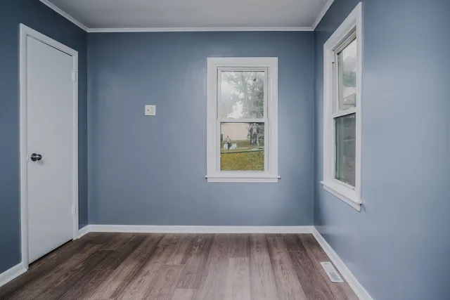 a view of an empty room and wooden floor