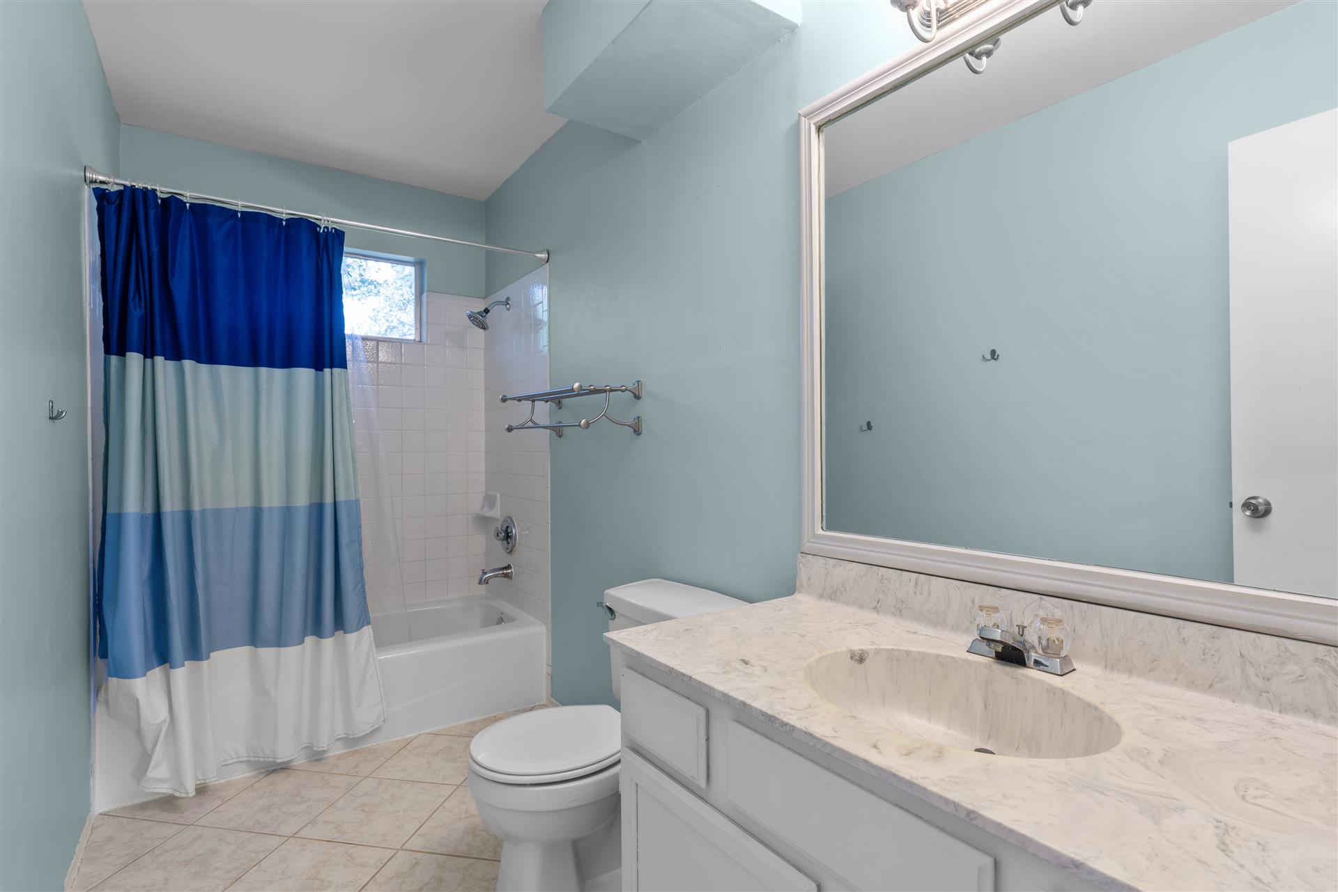 1710 Persimmon Road Cedar Park, TX 78613 - Photo 25 of 33 A pristine secondary full bathroom with a spacious vanity, large mirror, and tiled shower area awaits.