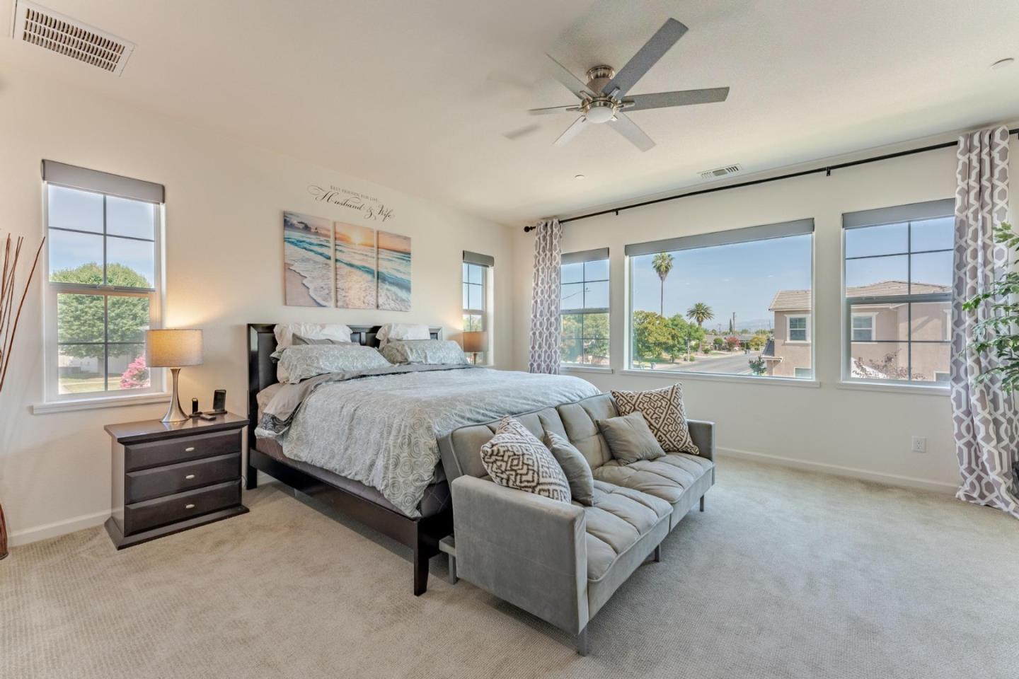 767 Sullivan Way Gilroy, CA 95020 - Photo 16 of 37 a spacious bedroom with a bed a couch and large window