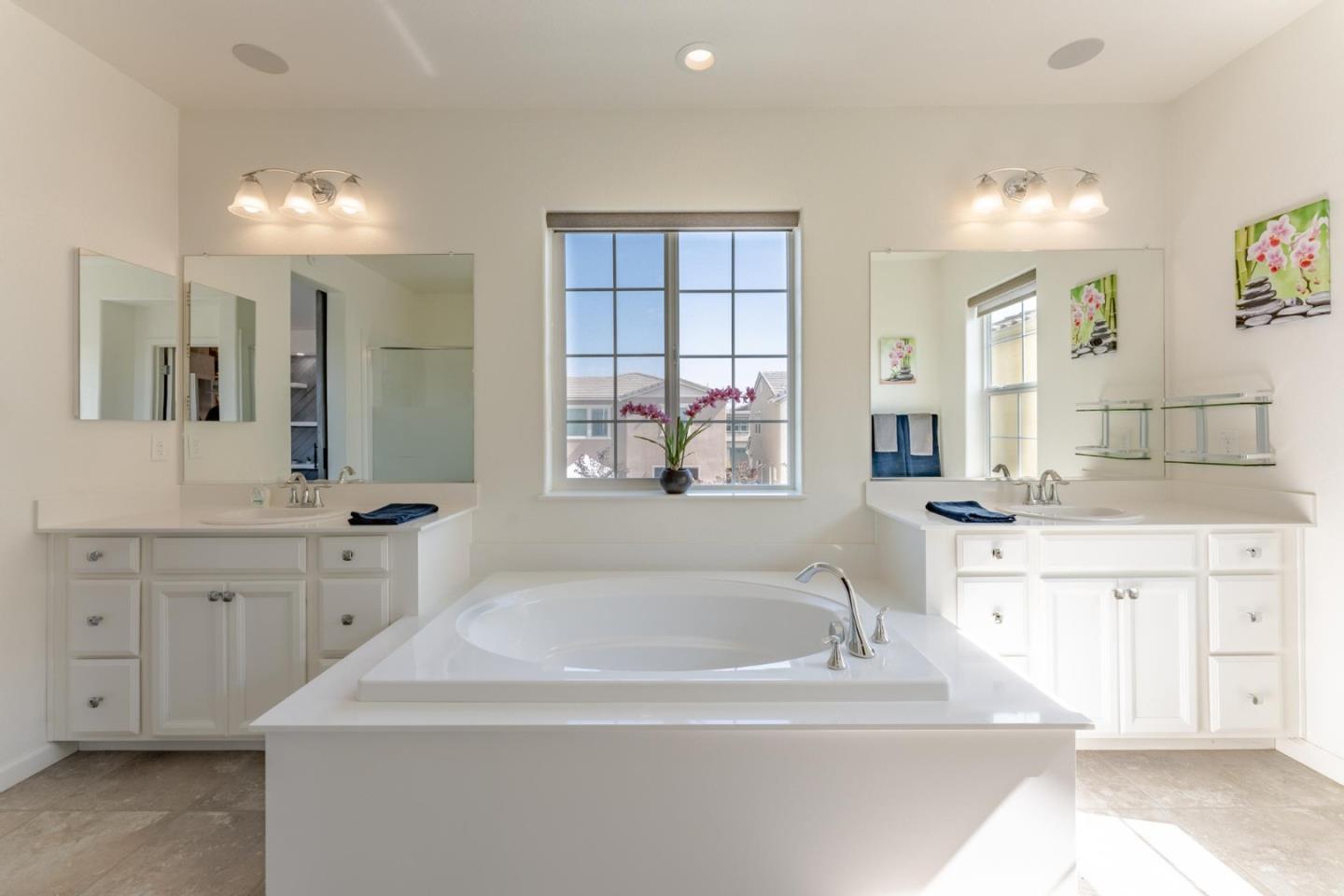 767 Sullivan Way Gilroy, CA 95020 - Photo 19 of 37 a spacious bathroom with a sink a large mirror and a bathtub