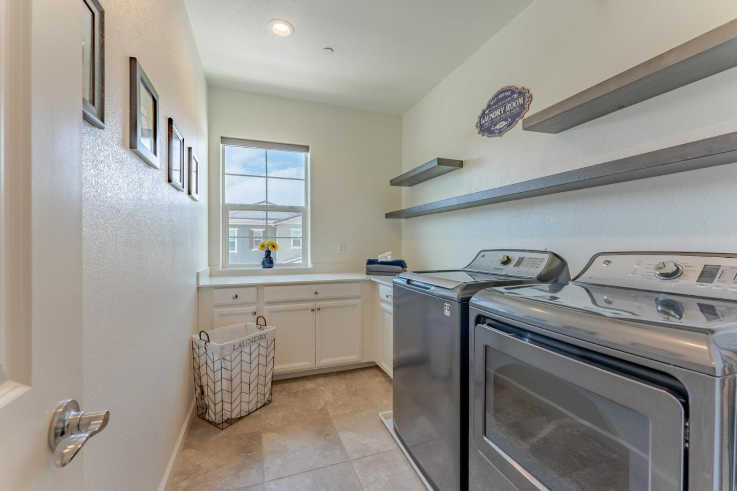 767 Sullivan Way Gilroy, CA 95020 - Photo 21 of 37 a utility room with cabinets washer and dryer