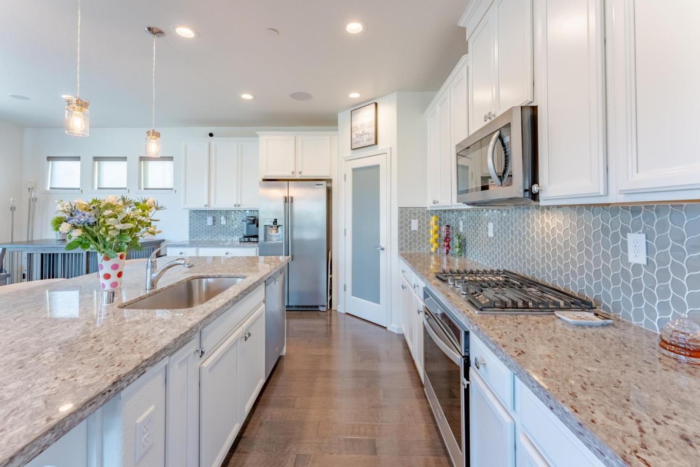 767 Sullivan Way Gilroy, CA 95020 - Photo 10 of 37 a kitchen with stainless steel appliances granite countertop a sink stove and refrigerator