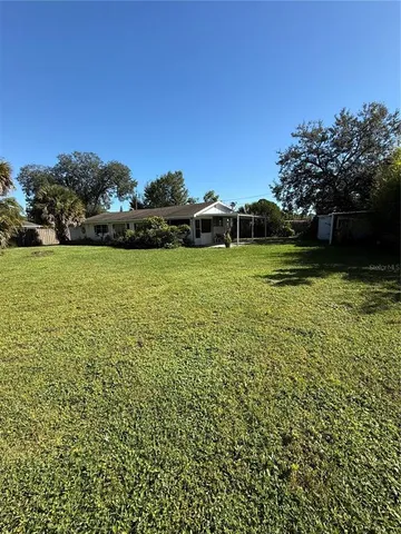 a view of a field of grass and trees