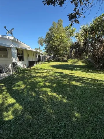 a front view of a house with a yard table and chairs