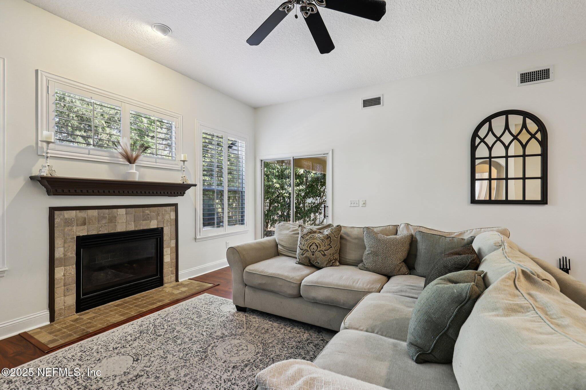 333 Stokes Creek Drive St. Augustine, FL 32095 - Photo 13 of 68 a living room with furniture a window and a fireplace
