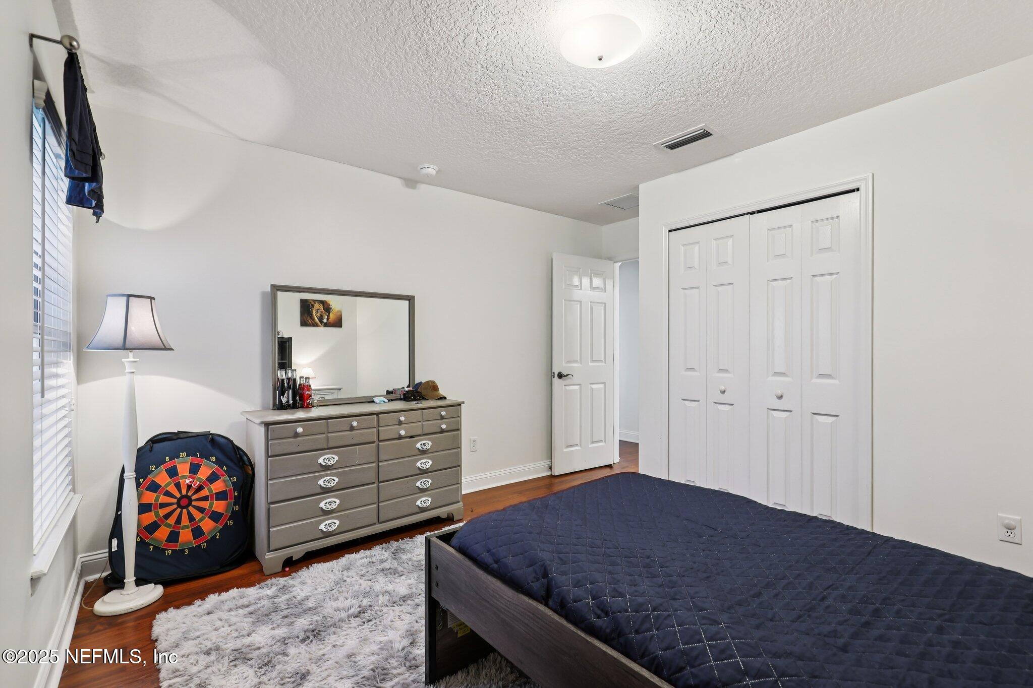 333 Stokes Creek Drive St. Augustine, FL 32095 - Photo 32 of 68 a bedroom with a bed and a dresser in it