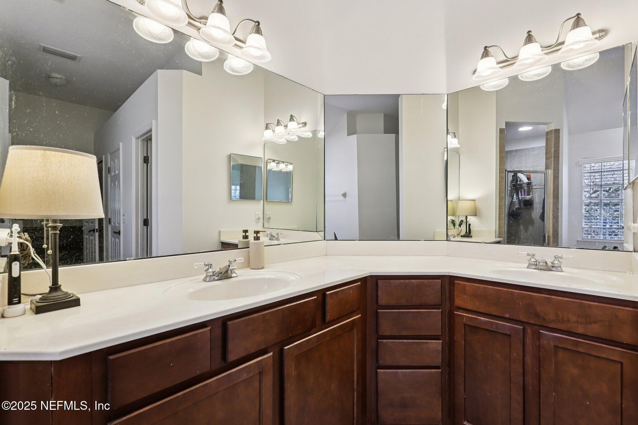 333 Stokes Creek Drive St. Augustine, FL 32095 - Photo 39 of 68 a bathroom with a sink vanity and a mirror