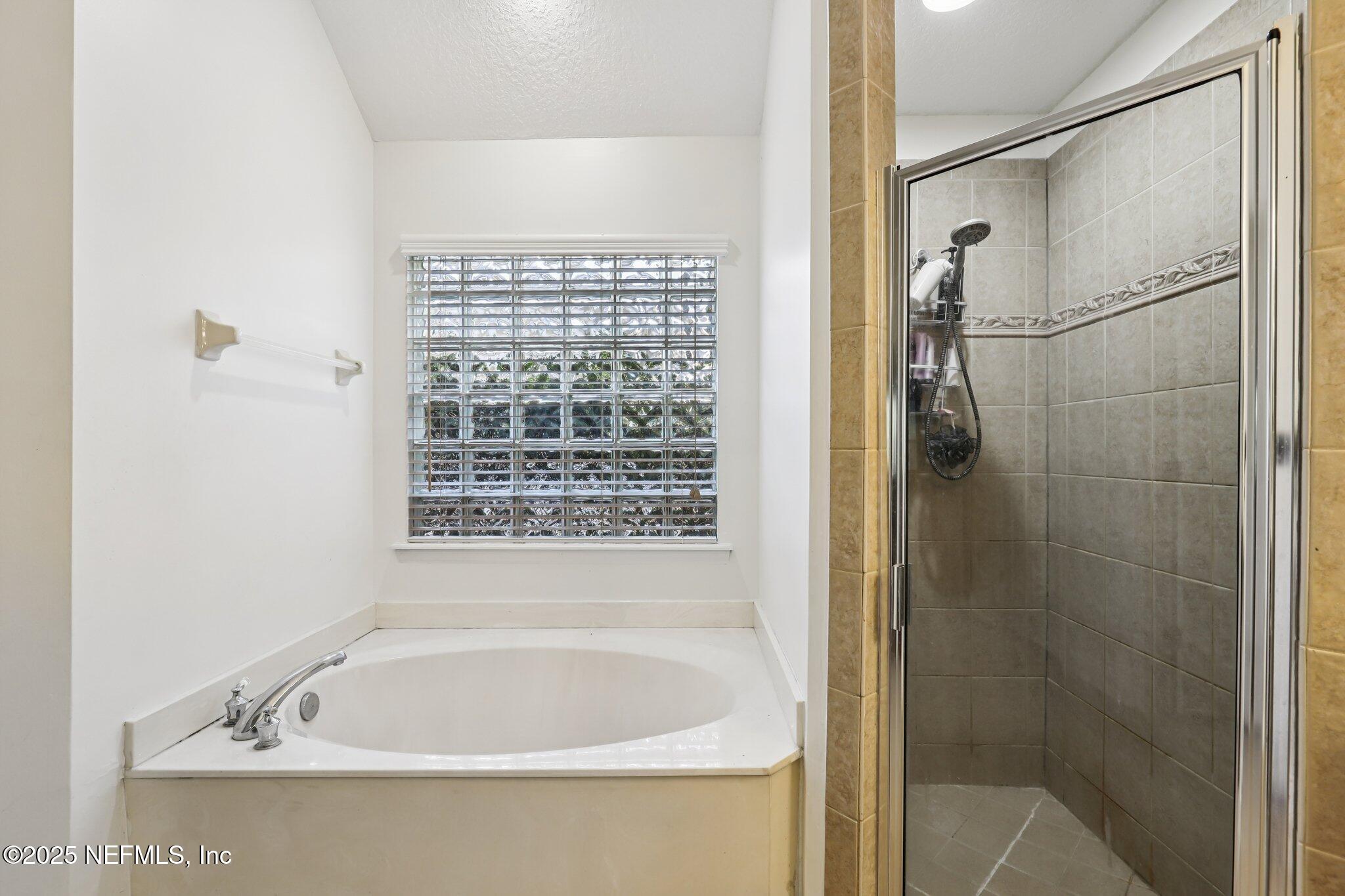 333 Stokes Creek Drive St. Augustine, FL 32095 - Photo 40 of 68 a bathroom with a bathtub and a shower
