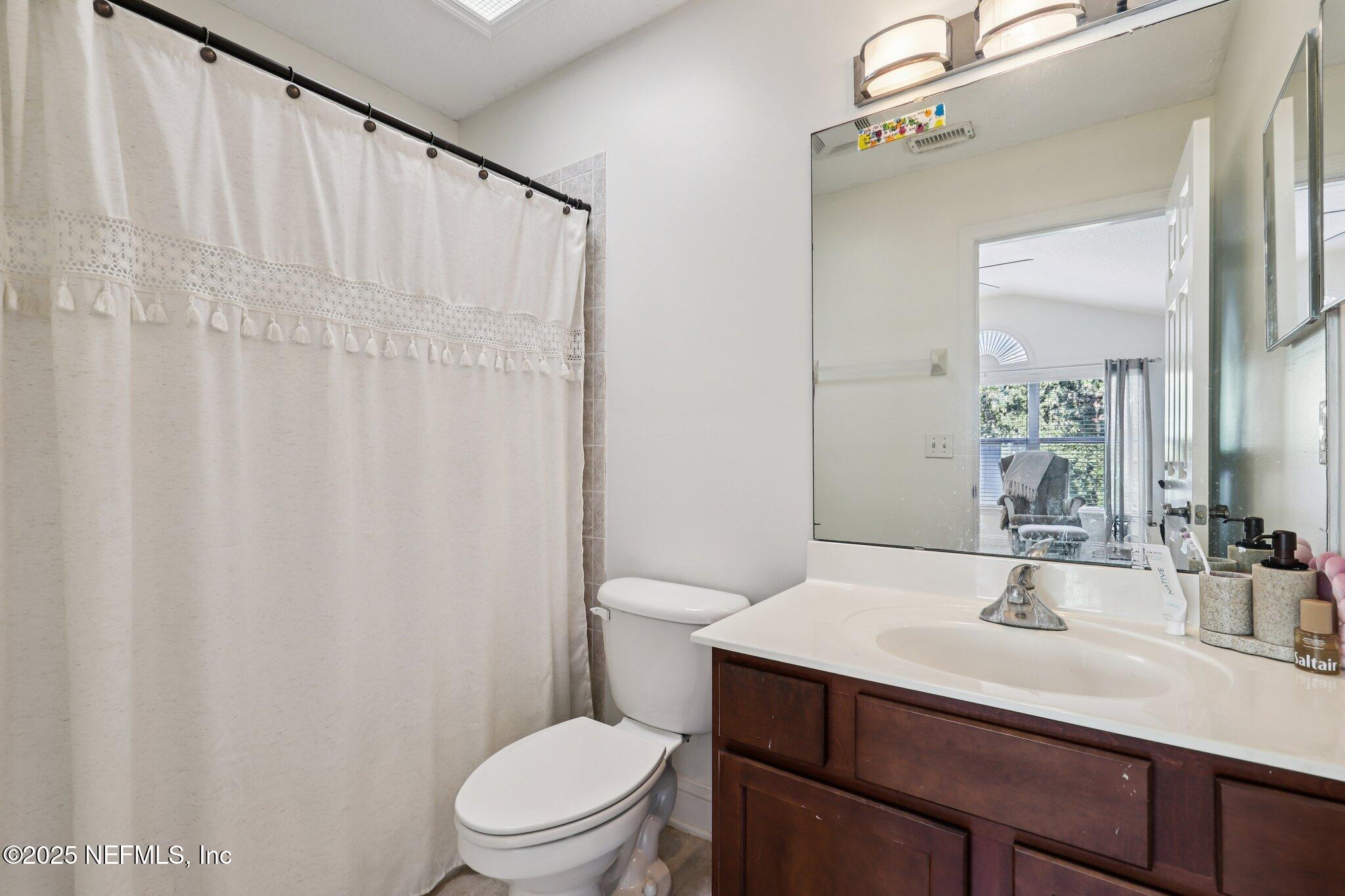 333 Stokes Creek Drive St. Augustine, FL 32095 - Photo 44 of 68 a bathroom with a sink vanity mirror and toilet