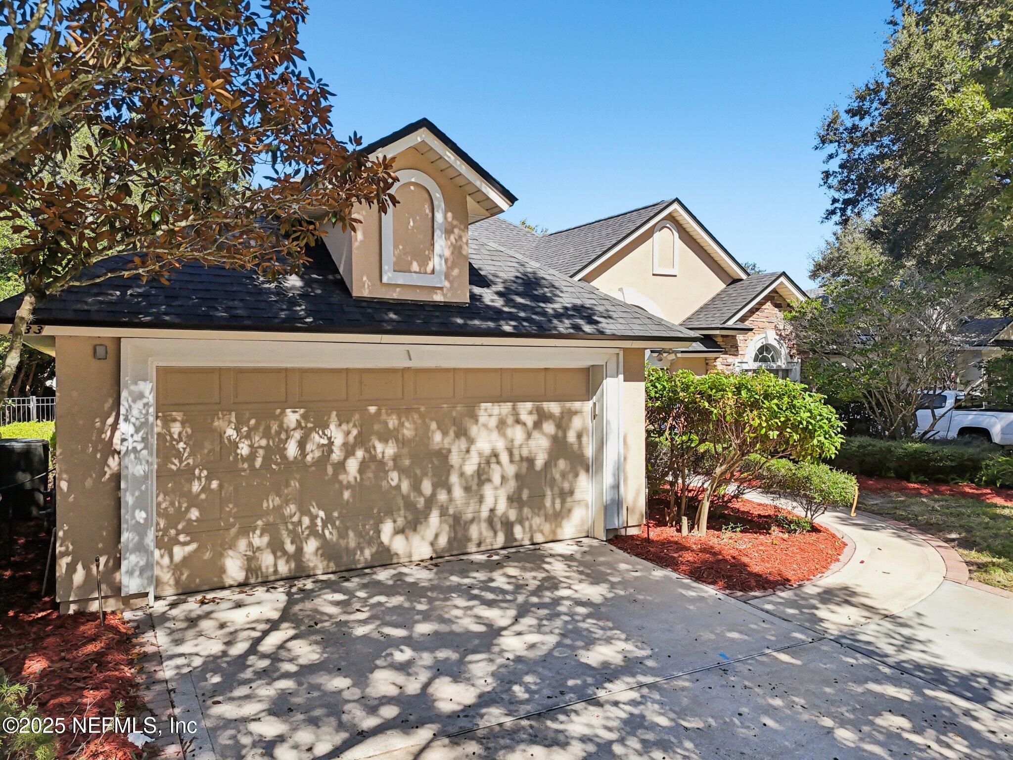 333 Stokes Creek Drive St. Augustine, FL 32095 - Photo 50 of 68 a front view of a house with a yard and garage