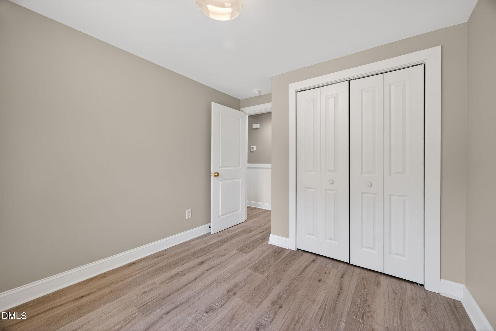 313 Crown Oaks Drive Raleigh, NC 27615 - Photo 56 of 60 a view of an empty room with wooden floor