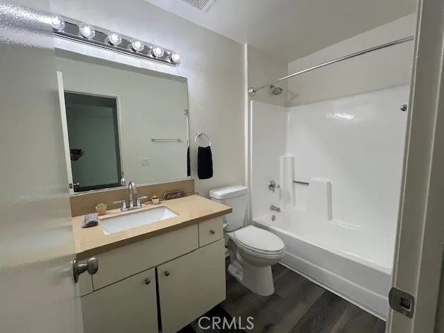a bathroom with a sink toilet double vanity and shower