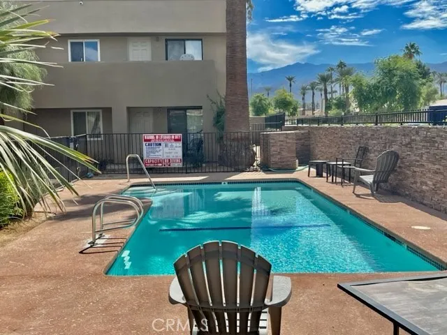 a view of a patio with chairs and a table