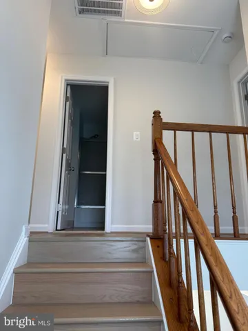 a view of staircase with white walls and a window