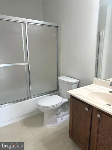 a white toilet sitting next to a bathroom sink