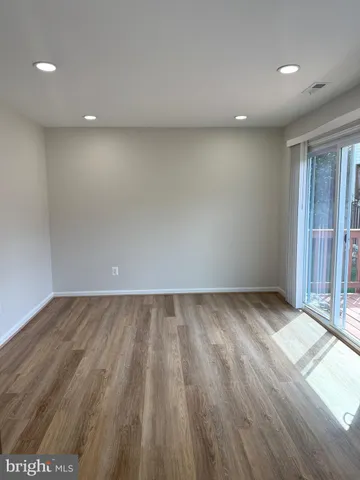 a view of an empty room and wooden floor