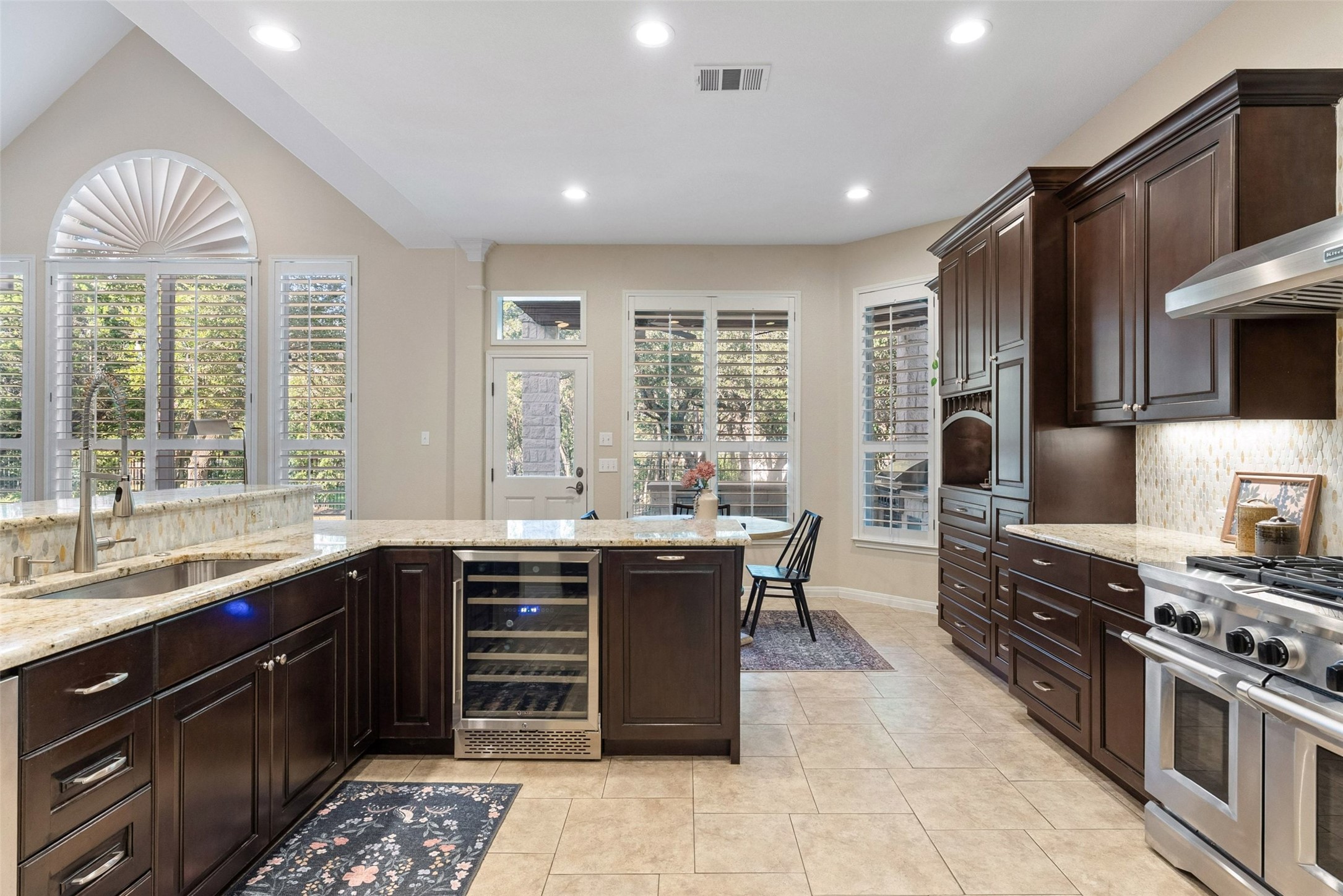 8215 Dark Ridge Cove Austin, TX 78737 - Photo 16 of 40 Culinary aspirations come alive in this kitchen, boasting premium appliances, upgraded cabinets, granite countertops, and ample space for entertaining.