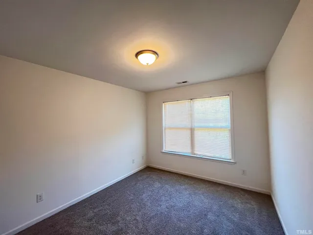 an empty room with a empty space and a window