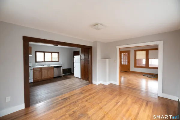 a view of a room with wooden floor and a window