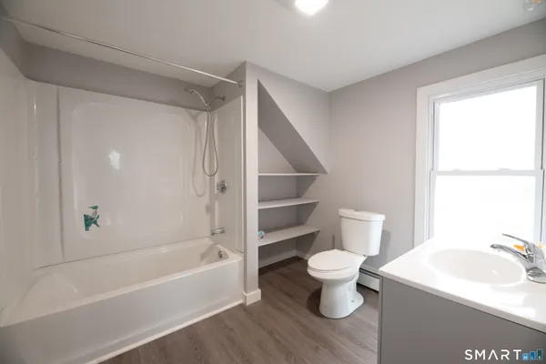 a bathroom with a toilet and a bathtub