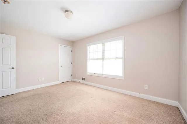 an empty room with a empty space and a window