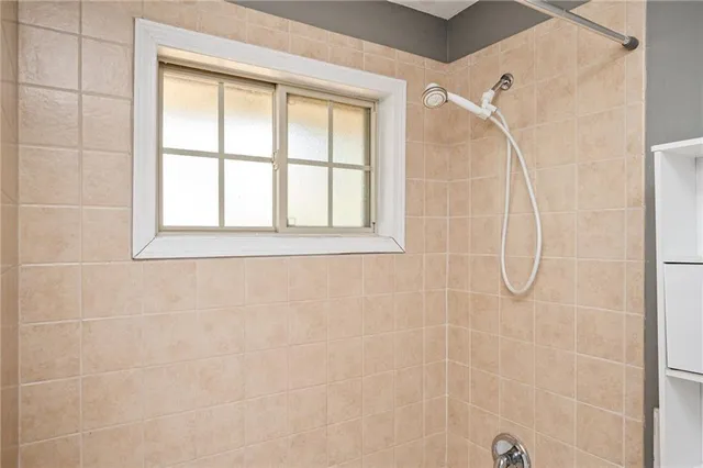 a bathroom that has a glass shower door