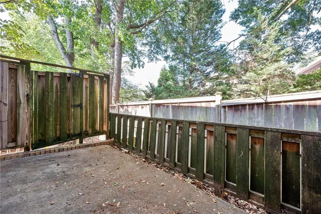 a view of a backyard with wooden fence