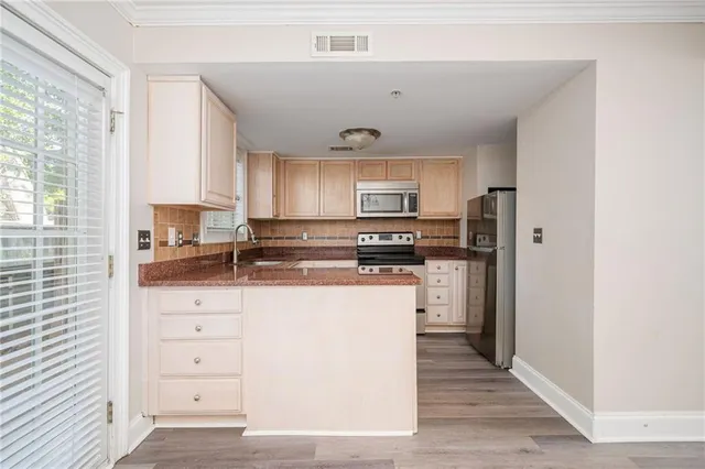 a kitchen with stainless steel appliances a refrigerator sink and cabinets