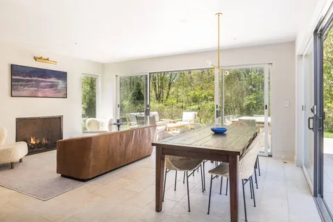 a living room with a large window and a table