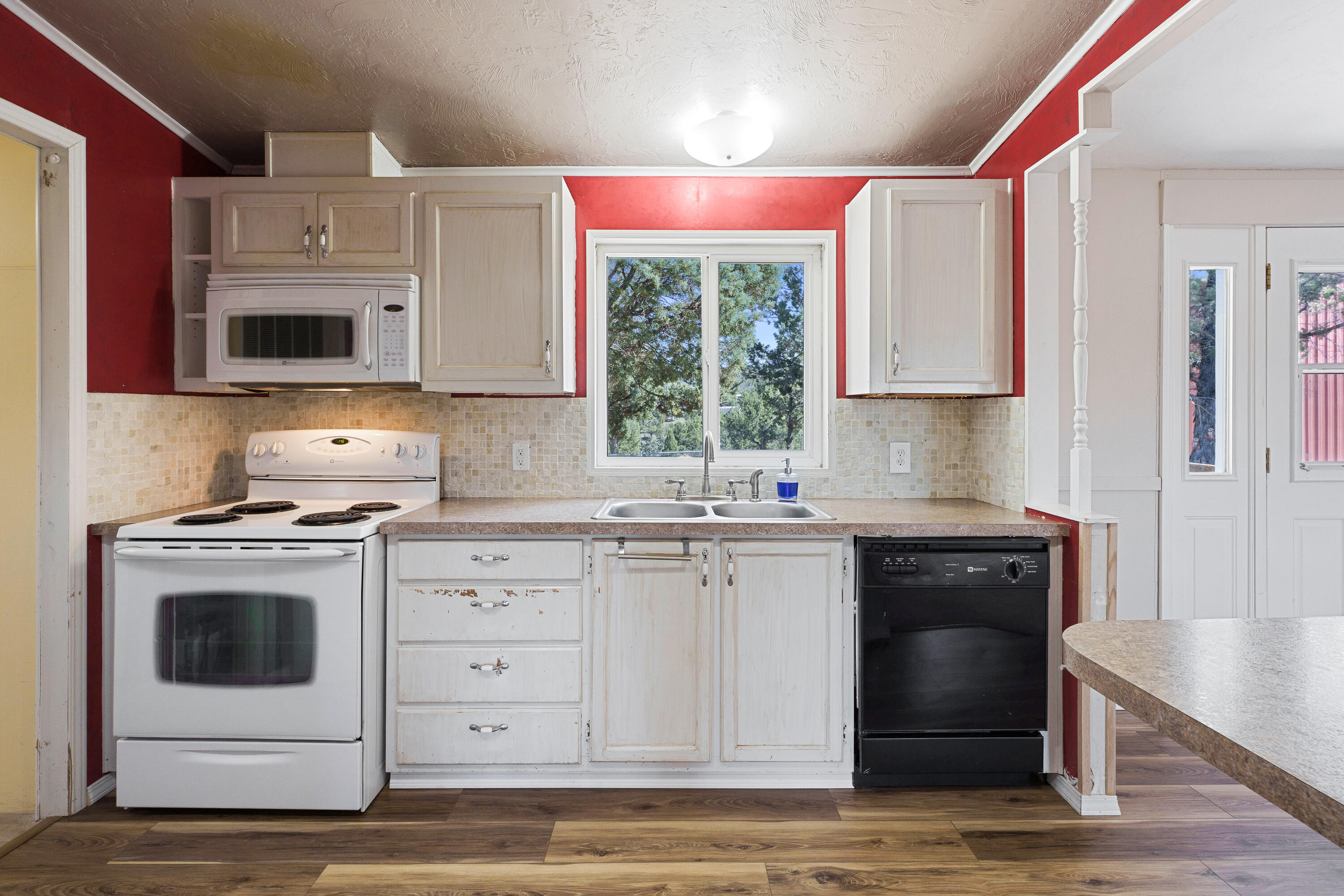 5674 Southeast Davis Loop Prineville, OR 97754 - Photo 12 of 48 a kitchen with cabinets appliances and a window