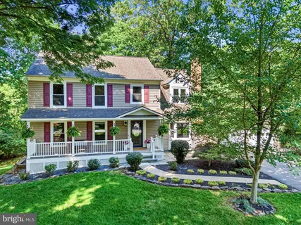 a view of a house with a yard balcony and couches