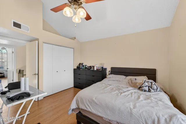 a bedroom with a bed and a chandelier