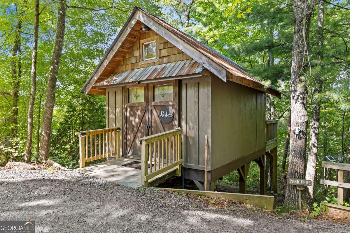 120 Community Hill Drive Blue Ridge, GA 30513 - Photo 2 of 57 a view of a small house with a small yard and wooden fence